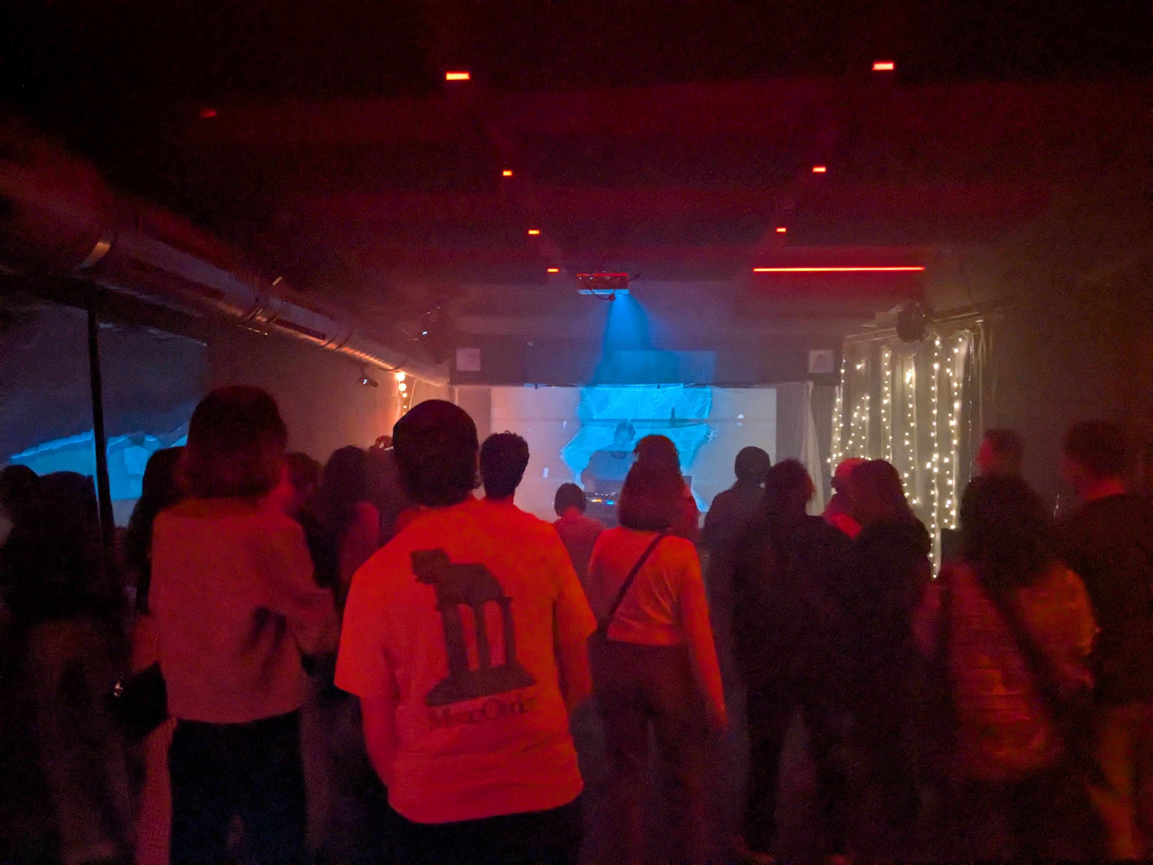 Magenta painterly projection across performers and audience at Acud, Berlin, March 2025